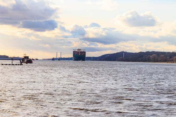 Huge cargo container ship sailing on the Elbe river, Hamburg, Germany