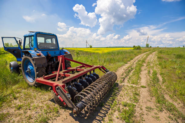 Agriculture. Tractor, Plowing Field on a Farm. Tillage. Agricultural Equipment. Preparing the Soil for sowing. Work Plow Machine. Harvesting Season. stock photo