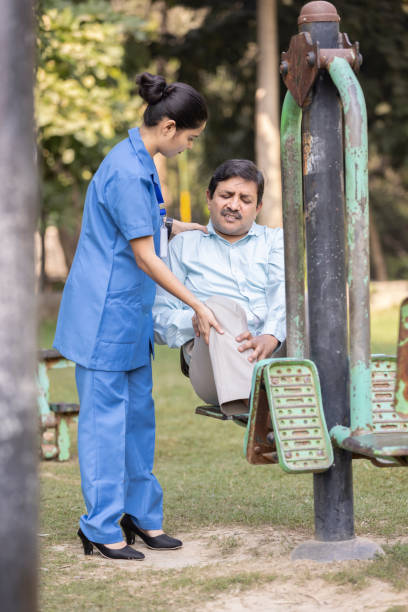 istock Nurse doctor senior care exercise physical therapy ecercising help assistence retirement  elderly man at park. 1446690693