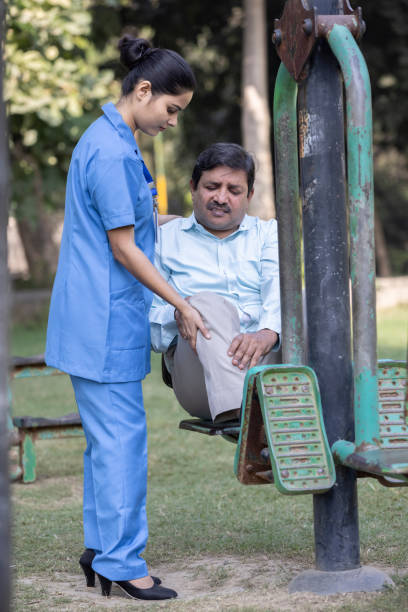 istock Nurse doctor senior care exercise physical therapy ecercising help assistence retirement  elderly man at park. 1446690695