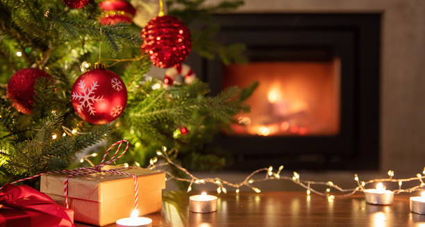 istock Christmas tree decoration and Xmas presents on table, burning fireplace background 1446691200