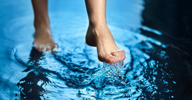 istock Woman foot step on blue Water in Splash 1446691389