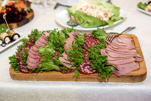Thinly sliced ham on plate