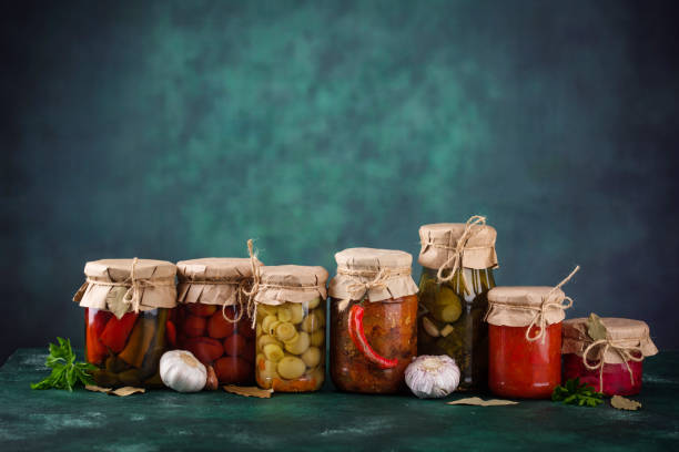 Pickled vegetables in glass jars. stock photo
