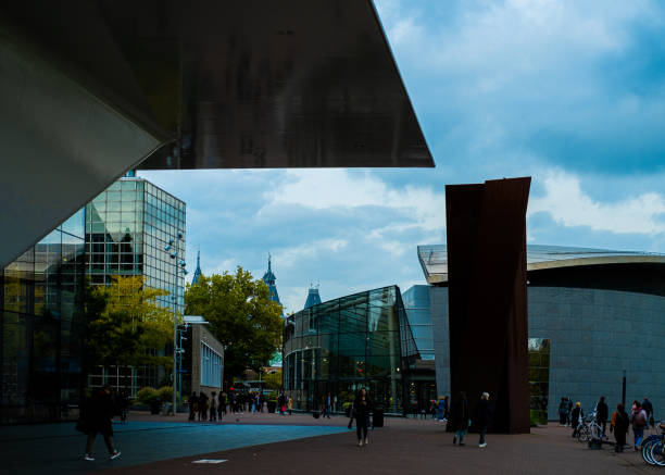 Amsterdam, Netherlands - July 2, 2012: Rijksmuseum. It is a Dutch national museum dedicated to arts and history. The museum is located at the Museum Square (Museumplein) in the borough Amsterdam South. People are enjoying a beautiful day outside.