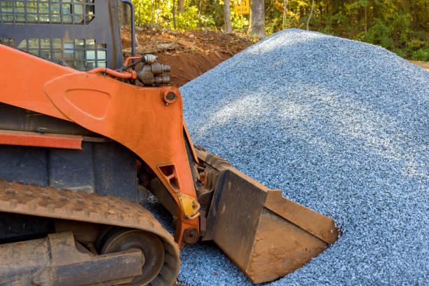 istock Wheel loader excavator for unloading crushed stone during the repair road works in construction site 1446699498