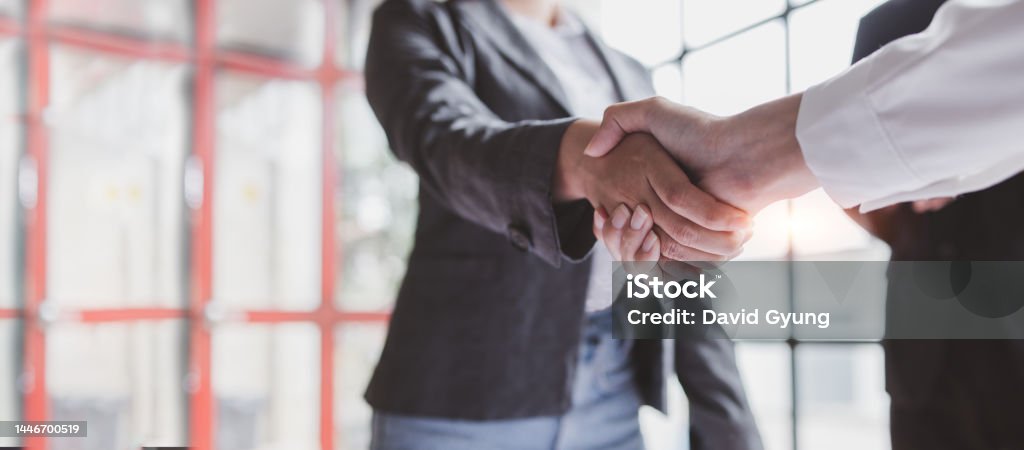 Business handshake for teamwork of business merger and acquisition,successful negotiate,hand shake,two businessman shake hand with partner to celebration partnership and business deal concept Handshake Stock Photo