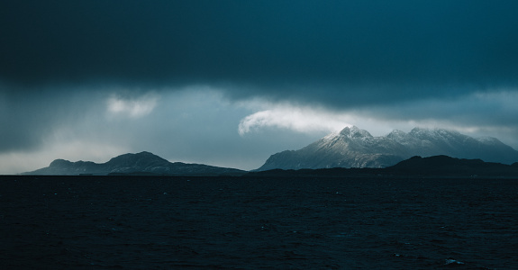 View at dark sea and Lofoten Islands on background