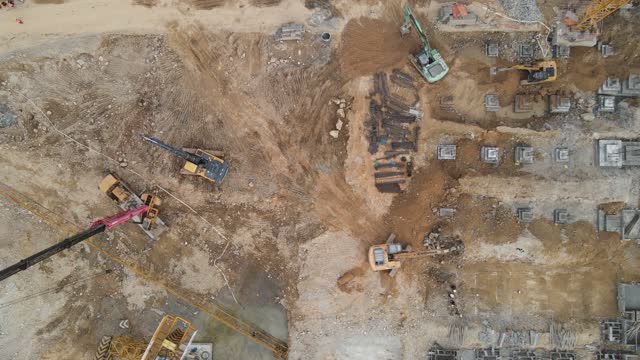 Machines and workers are working on the loess construction site