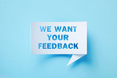 We Want Your Feedback Written Rectangular Shaped White Chat Bubble Sitting On Blue Background