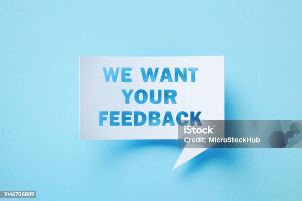 We Want Your Feedback Written Rectangular Shaped White Chat Bubble Sitting On Blue Background Stock Photo - Download Image Now