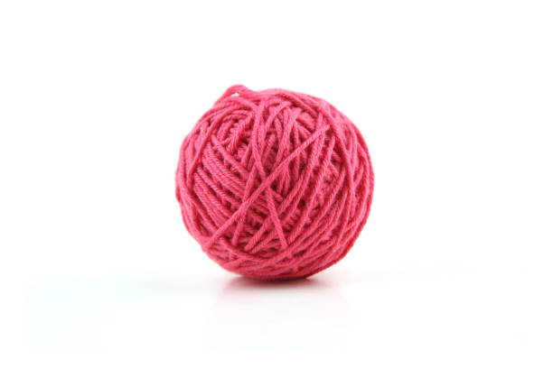 istock Pink cotton thread ball isolated on white background. 1446708173