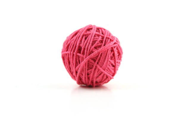 istock Pink cotton thread ball isolated on white background. 1446708208