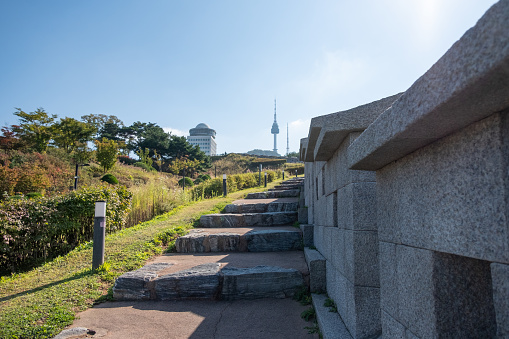 Walkway next to Hanyangdoseong Wall or Seoul City Wall in Namsan park, with the view of N Seoul Tower. South Korea