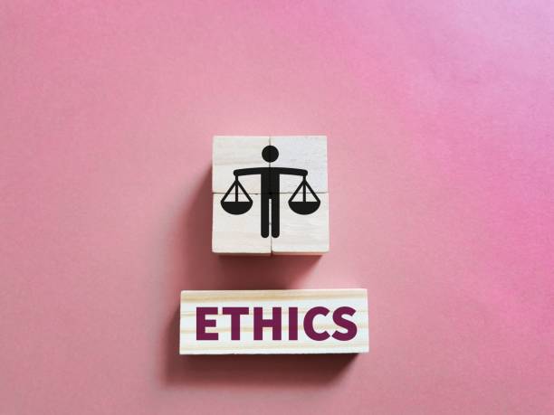 istock Business ethics concept on wooden cubes against pink background. 1446710084