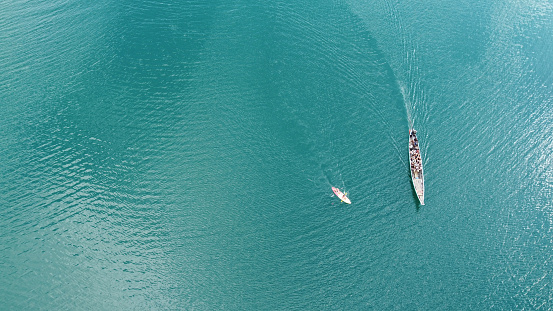 Aerial view from a drone of Thai traditional longtail fishing boat and kayak . Top view. Copy space.
