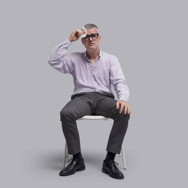 istock Uncomfortable emotional man sitting and sweating 1446712329