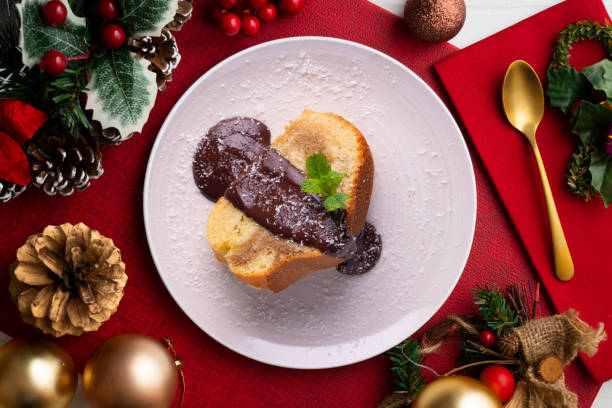 istock Coffee cake with melted chocolate on top on a table with Christmas decorations. Christmas Dessert. 1446713246