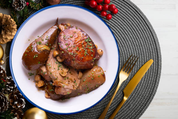 istock Low temperature cooked pork loin with pears on a decorated table on Christmas week. Typical Spanish tapa recipe. 1446713387