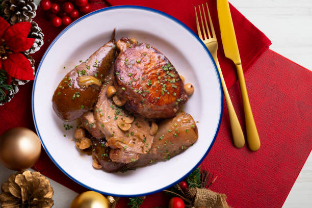 istock Low temperature cooked pork loin with pears on a decorated table on Christmas week. Typical Spanish tapa recipe. 1446713393