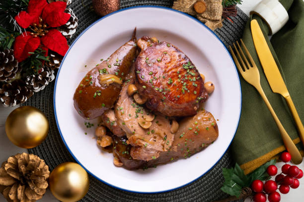 istock Low temperature cooked pork loin with pears on a decorated table on Christmas week. Typical Spanish tapa recipe. 1446713397