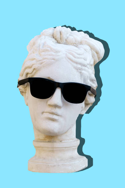 istock Antique sculpture female head in trendy sunglasses on an empty blue minimal background. Design, art, fashion, pop style concept. 1446713607