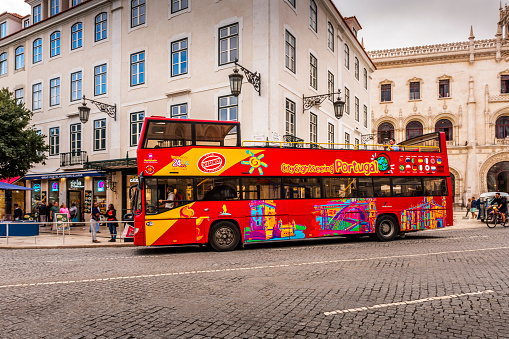 Lisbon, Portugal - October 31, 2022: sightseeing bus with tourists in Lisbon