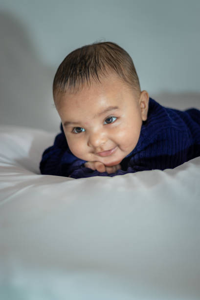 istock infant boy lying cute facial expression with white background at indoor 1446717427