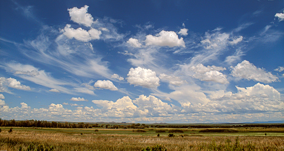 A stunning cloudscape hovers over the horizon creating a dramatic panoramic image.