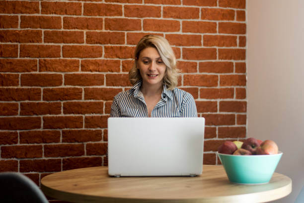 istock Woman freelancer/designer working on computer from home office 1446717833