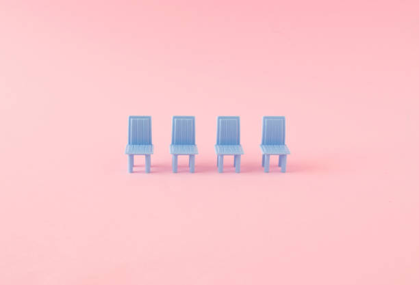 Blue chairs in a row on a pastel pink background. Minimal creative concept.
