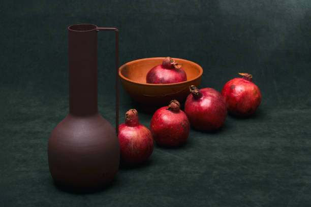 istock Still life with ripe pomegranates and a vase 1446718766
