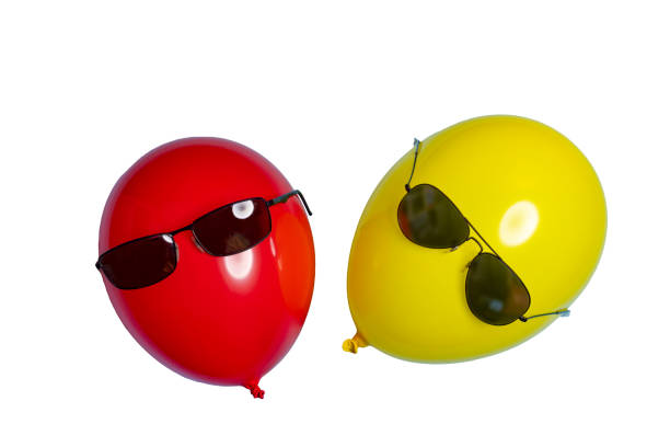 istock Red and yellow balloons with sunglasses 1446721644