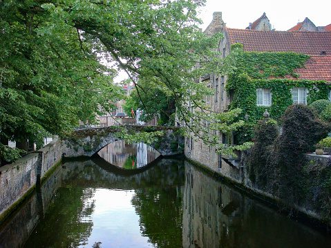 Beautiful view of river, old town and bridge on a summer day. Bruges. Belgium.