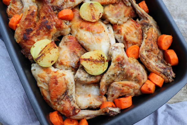 istock Roasted Rabbit Haunches in Pan with Stewed Vegetables on Rustic Wooden Table Surface 1446723995