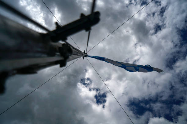 flag flies against a blue white sky on a summer day in Bavaria