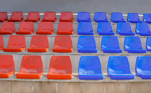 Symmetry tier of empty blue and red seats on a soccer field. Seats in the colors of Barça.