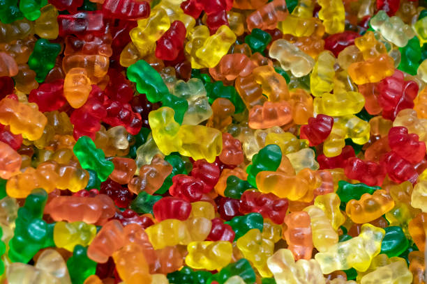 istock Gummy Bears Candy. gelatin bears background. selective focus 1446727385