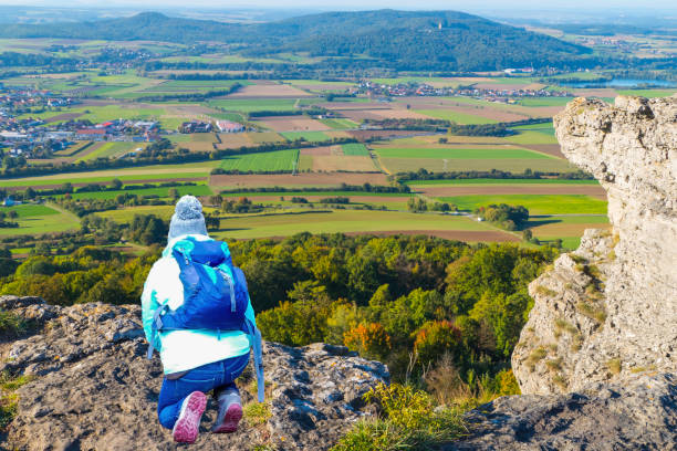 Woman sits on Rock of Table Mountain Germany Trekking in Germany bad staffelstein stock pictures, royalty-free photos & images