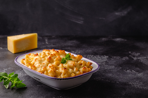 American mac and cheese, macaroni pasta in cheesy sauce.