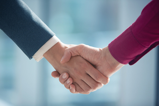 Close Up of business people shaking hands after contract meeting at customer office. Business etiquette, congratulation, merger and acquisition concepts.