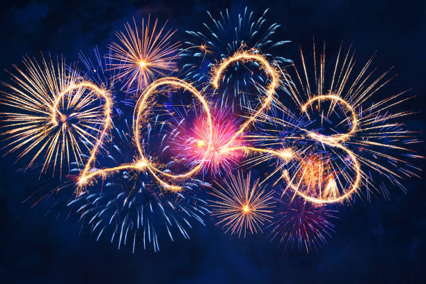 istock 2023 happy new year concept with sparkles in the night sky. Sparkle firework on black background for banner 1446736859