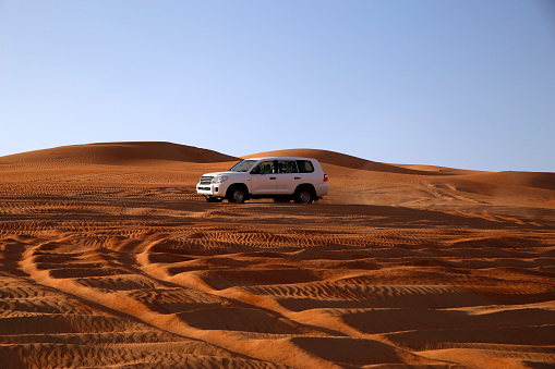 A four by four driving in the United Arab Emirate of Abu Dhabi on a jeep safari through the desert. You will really get the feeling of being in the middle of nowhere.