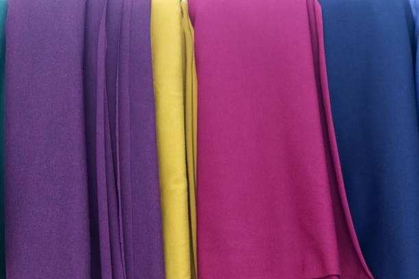 Detailed close up view on samples of cloth and fabrics in different colors found at a fabrics market.