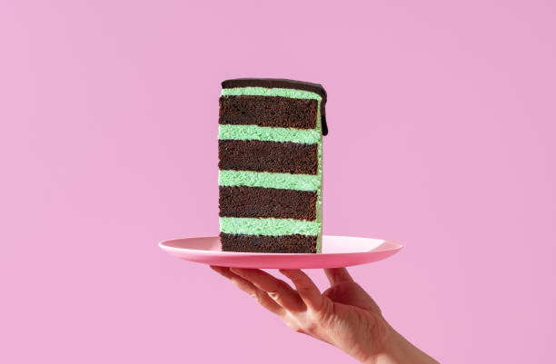istock Layered cake slice on a plate, minimalist on a purple background. 1446740837