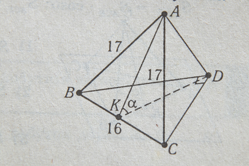 geometry drawing on page of old yellow book as background, algebra book as background