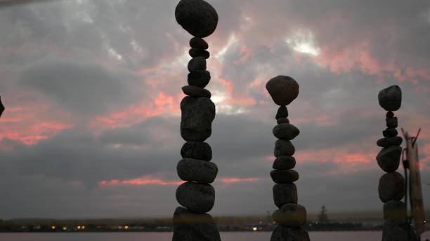 istock Rock balancing and cloudy dramatic sky on sunset. Stack of stones in balance. 1446742758