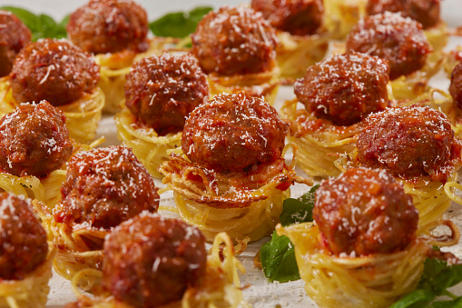 Spaghetti and Meatball Nest Bites with Fresh Basil Made in a Mini Muffin Tin
