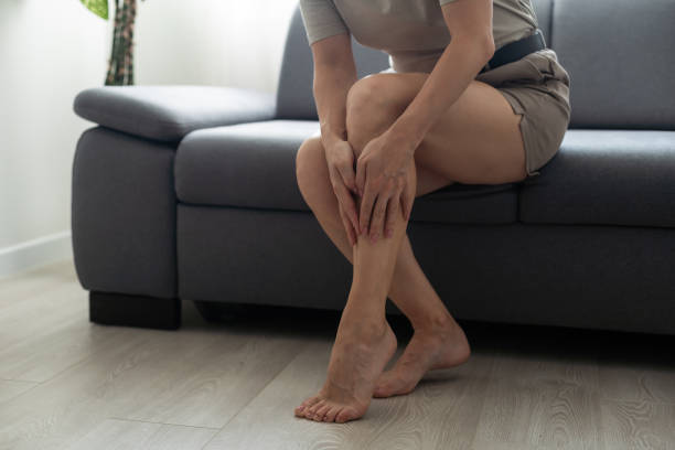 istock a woman is holding her leg 1446745061