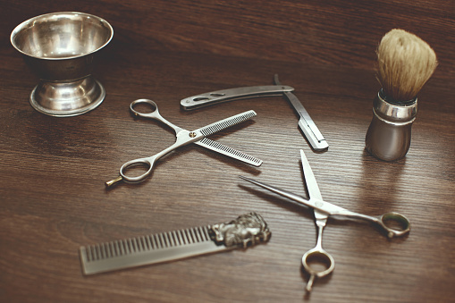Shaving accessories and tools of barber shop on wooden background